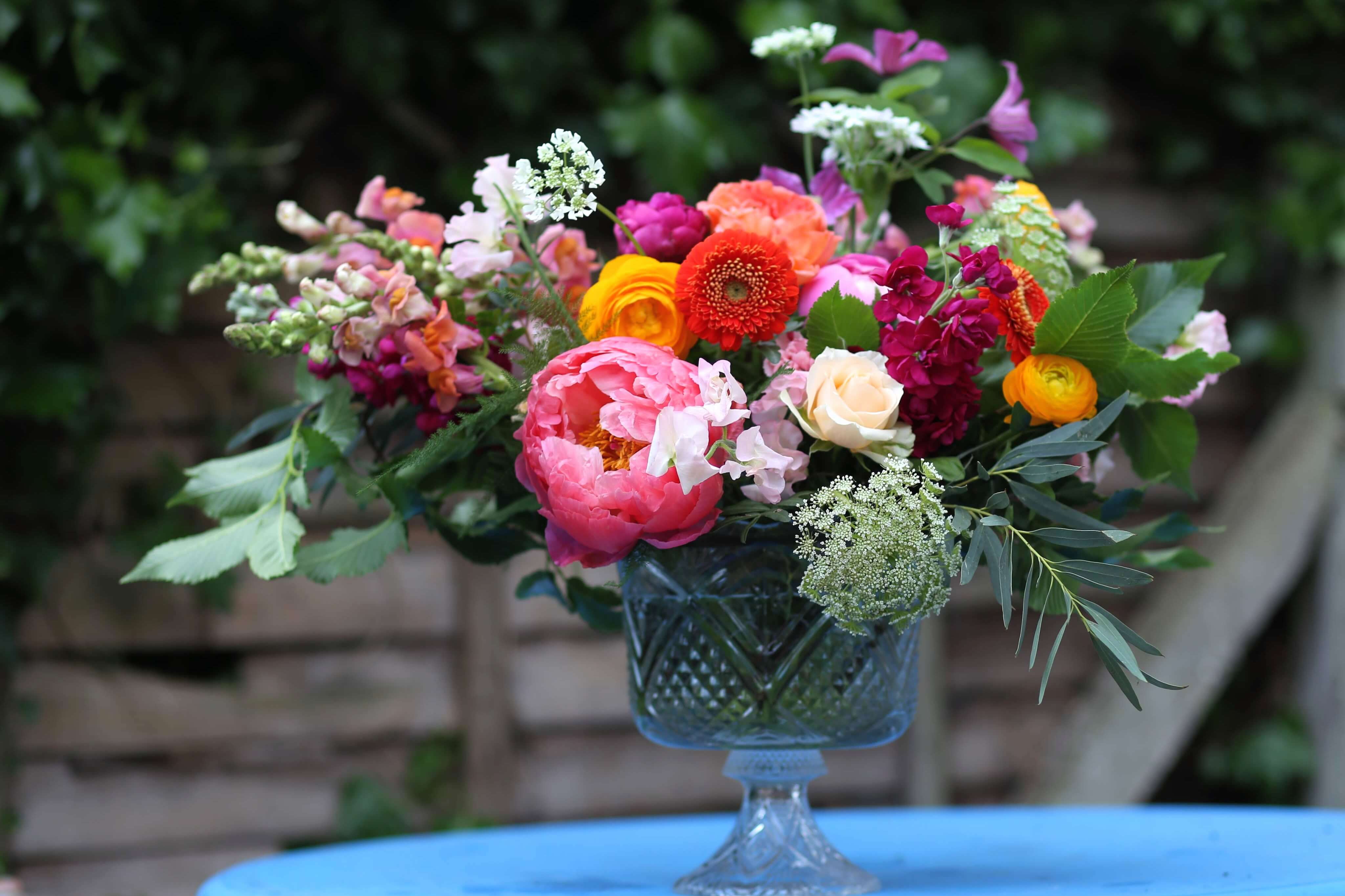 coral, yellow, orange, peach and pink wedding ceremony flowers by Bettie Rose Flowers, Sussex Wedding florist. 