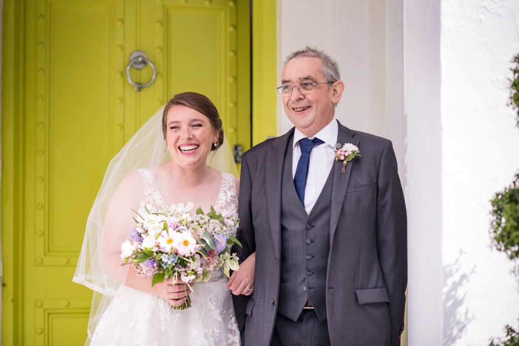 Happy bride holding her bouquet at Pangdean Barn