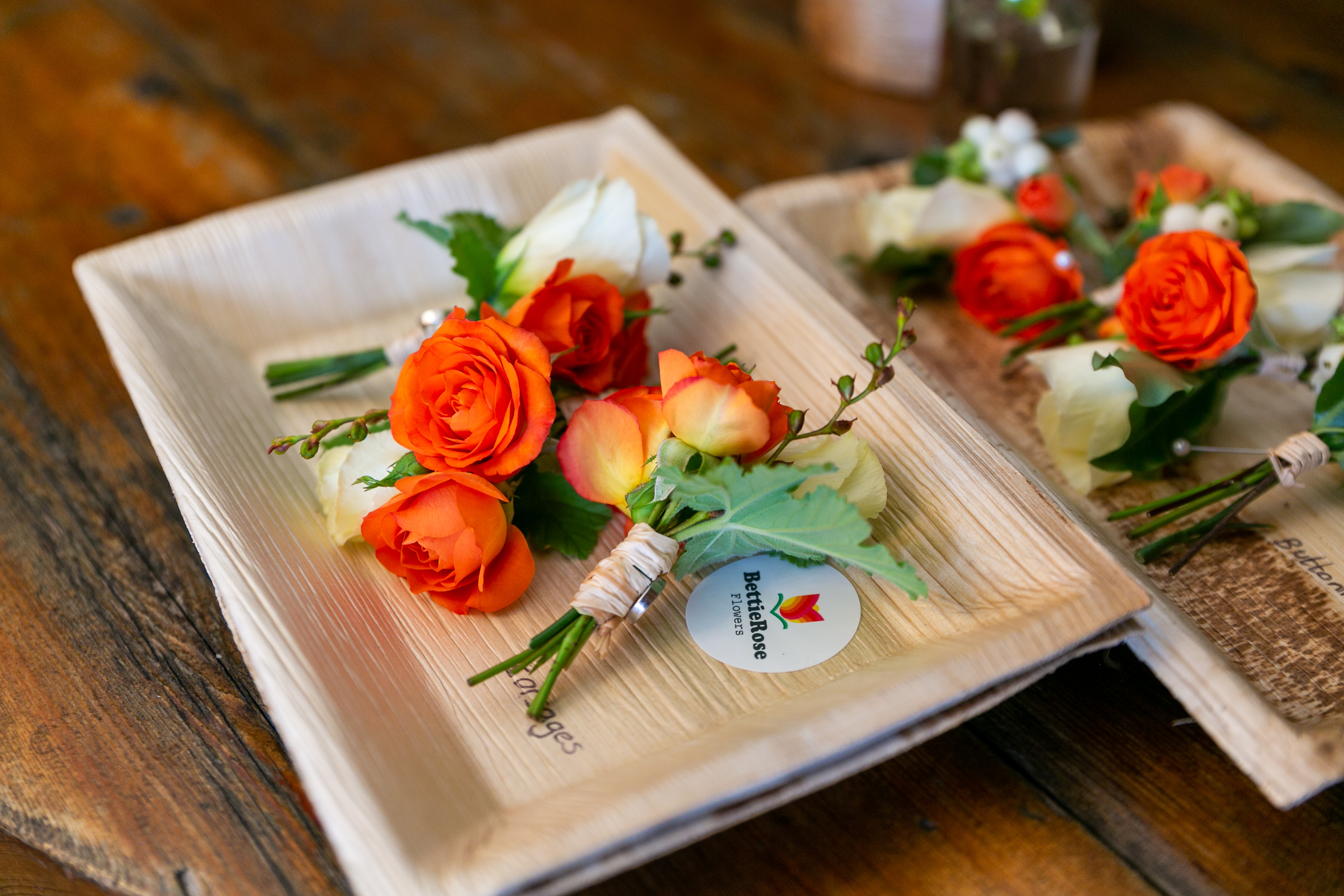 two groom's buttonholes waiting to be collected before the ceremony outdoors at pangdean barn