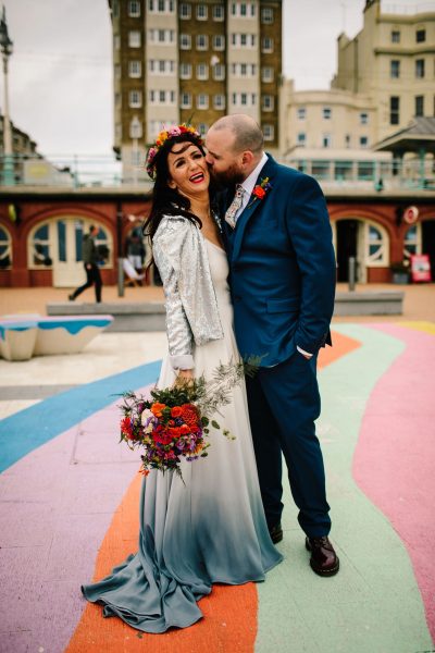 Bride and groom with flower crown on Brighton seafront