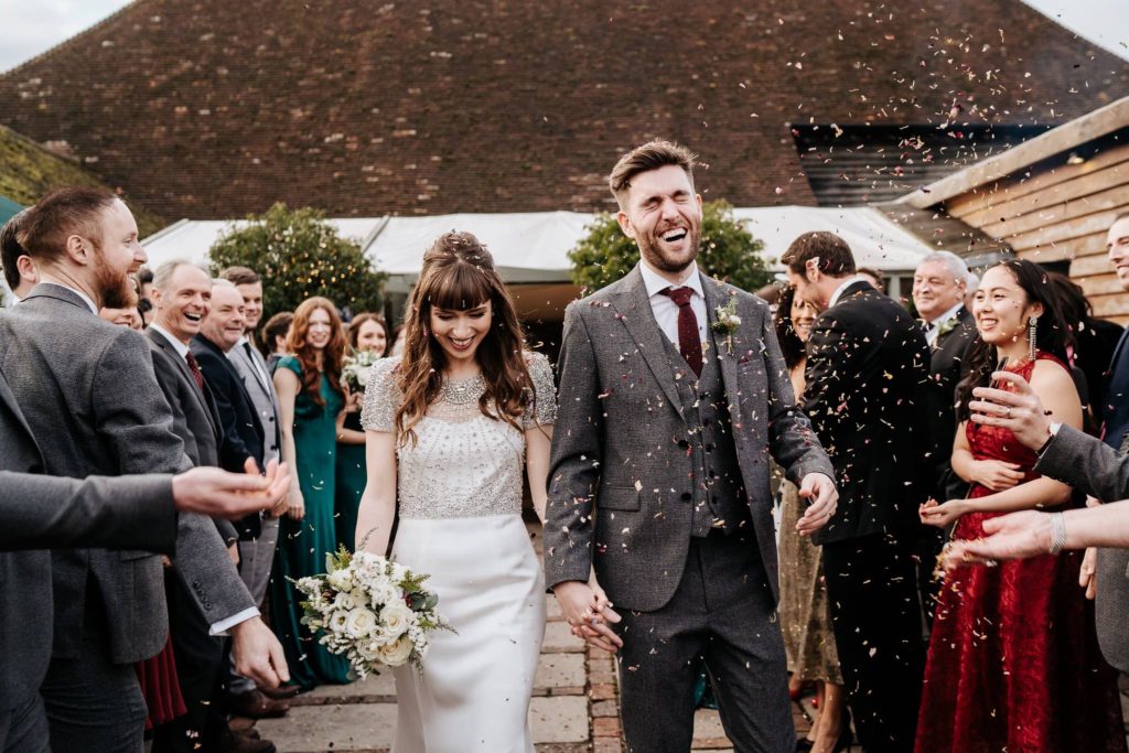 Bride and groom with confetti just married at Pangdean Barn Brighton