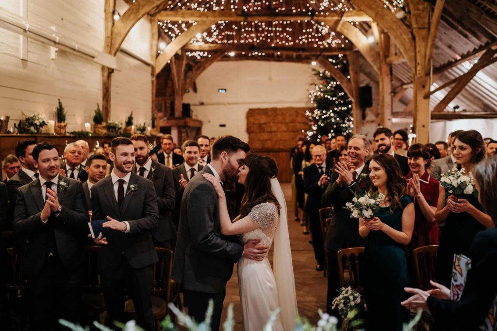 Christmas wedding at Pangdean barn, bride and groom kissing at the end of the ceremony