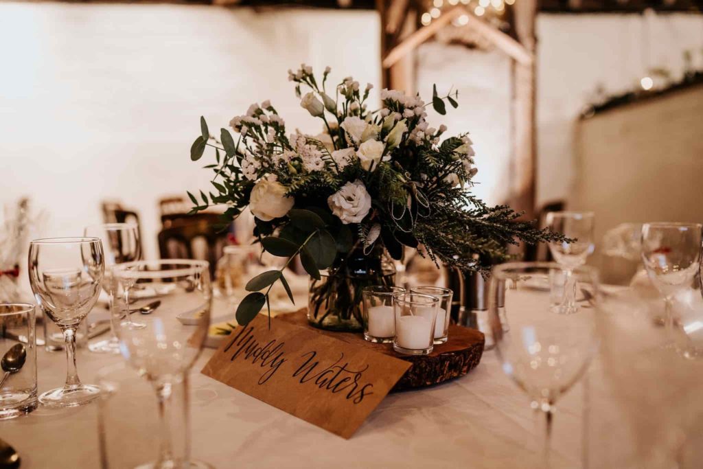 White flower table centres at Pangdean Barn Christmas wedding